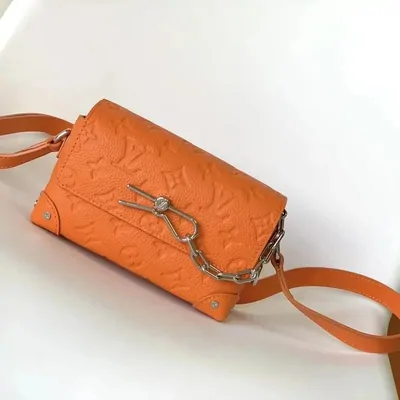 orange embossed-leather crossbody bag with silver hardware, studio shot